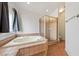 Luxurious ensuite bathroom features a tub, shower, and tile floors at 654 Mazelle Ln, Pahrump, NV 89060