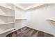 Walk-in closet with custom shelves and carpeted floor at 654 Mazelle Ln, Pahrump, NV 89060
