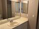 Well-lit bathroom with a vanity and mirror, providing a practical and comfortable space at 6865 Tamarus St # 202, Las Vegas, NV 89119