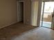 Cozy bedroom with carpet and sliding door to balcony, providing a relaxing retreat at 6865 Tamarus St # 202, Las Vegas, NV 89119