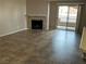 Inviting living room with fireplace and sliding door to balcony for natural light and fresh air at 6865 Tamarus St # 202, Las Vegas, NV 89119
