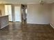 Open-concept living area with tile flooring and a view of the adjacent kitchen space at 6865 Tamarus St # 202, Las Vegas, NV 89119