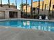 Inviting community pool with lounge chairs, perfect for relaxation and enjoying the outdoors at 6865 Tamarus St # 202, Las Vegas, NV 89119