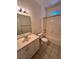 Clean bathroom featuring a vanity with sink, toilet, and a combined tub/shower with tile surround at 7255 W La Madre Way, Las Vegas, NV 89149