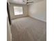 Cozy bedroom with neutral carpet, large window, and sliding door closet at 7255 W La Madre Way, Las Vegas, NV 89149