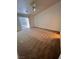 A bright and airy bedroom with neutral carpet, ample natural light from the sliding door, and vaulted ceiling at 7255 W La Madre Way, Las Vegas, NV 89149