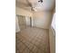 Neutral bedroom with tile flooring, mirrored closet, and a ceiling fan, providing a comfortable space at 7255 W La Madre Way, Las Vegas, NV 89149
