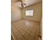 Minimalist bedroom with tile floors, a ceiling fan, and a bright window, creating a serene retreat at 7255 W La Madre Way, Las Vegas, NV 89149