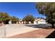 A well-maintained single-story house featuring a three-car garage and desert landscaping at 7255 W La Madre Way, Las Vegas, NV 89149