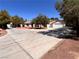 Charming single-story home with a manicured front yard, mature trees, and an expansive driveway at 7255 W La Madre Way, Las Vegas, NV 89149