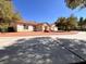 Charming single-story home with mature trees and a circular driveway at 7255 W La Madre Way, Las Vegas, NV 89149