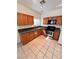 Traditional-style kitchen featuring wood cabinets, granite countertops, and stainless steel appliances for a timeless look at 7255 W La Madre Way, Las Vegas, NV 89149