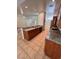 A modern kitchen with granite counters, brown cabinets, and stainless steel appliances at 7255 W La Madre Way, Las Vegas, NV 89149