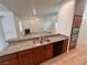 A modern kitchen with stainless steel appliances and granite countertops at 7255 W La Madre Way, Las Vegas, NV 89149