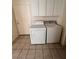 Well-lit laundry room with white washer, dryer and cabinets for optimal storage at 7255 W La Madre Way, Las Vegas, NV 89149