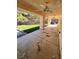 A covered patio with a ceiling fan overlooks the artificial grass lawn at 7255 W La Madre Way, Las Vegas, NV 89149
