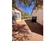 Side yard with gravel ground cover and mature trees, providing a clean and low-maintenance outdoor space at 7255 W La Madre Way, Las Vegas, NV 89149