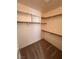 Spacious walk-in closet with shelves and hanging rods, offering ample storage in a neutral color palette at 7255 W La Madre Way, Las Vegas, NV 89149