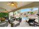 Backyard featuring a pool, spa, outdoor kitchen, covered patio with seating and retaining wall with landscaping at 733 Secret London Ave, Las Vegas, NV 89178