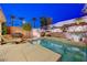Outdoor living space with a pool, spa, basketball court, and lush landscaping for the ultimate backyard retreat at 733 Secret London Ave, Las Vegas, NV 89178