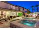 Backyard oasis with a sparkling pool, spa, patio seating, and lush landscaping for ultimate relaxation at 733 Secret London Ave, Las Vegas, NV 89178