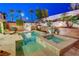 Charming backyard featuring a sparkling pool, relaxing spa, lush landscaping, and a BBQ at 733 Secret London Ave, Las Vegas, NV 89178