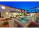 Charming backyard featuring a sparkling pool, relaxing spa, covered patio, and a well-manicured lawn at 733 Secret London Ave, Las Vegas, NV 89178