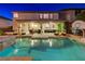 Charming backyard featuring a sparkling pool, relaxing spa, covered patio, and a well-manicured lawn at 733 Secret London Ave, Las Vegas, NV 89178