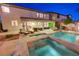 Inviting backyard retreat with pool, spa, covered patio, and manicured landscaping for outdoor living at 733 Secret London Ave, Las Vegas, NV 89178