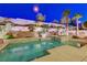 Luxurious backyard with a swimming pool, spa, and beautifully landscaped surroundings for outdoor enjoyment at 733 Secret London Ave, Las Vegas, NV 89178
