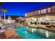 Charming backyard featuring a sparkling pool, relaxing spa, covered patio, and a well-manicured lawn at 733 Secret London Ave, Las Vegas, NV 89178