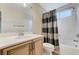 Bathroom featuring a shower-tub combo, wooden vanity, and a large mirror at 733 Secret London Ave, Las Vegas, NV 89178