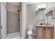 Well-lit bathroom featuring a walk-in shower, modern toilet, granite countertop and vanity at 733 Secret London Ave, Las Vegas, NV 89178