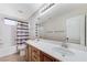 Bright bathroom featuring a double vanity, shower-tub combo and tiled floors at 733 Secret London Ave, Las Vegas, NV 89178