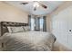 Bedroom features a patterned bedspread, bedside tables, and a closet at 733 Secret London Ave, Las Vegas, NV 89178