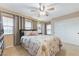 Bedroom features a ceiling fan, plush carpet, a large window and a closet with sliding doors at 733 Secret London Ave, Las Vegas, NV 89178