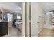 Bright bedroom featuring plush carpet, large windows and a view into the attached bathroom at 733 Secret London Ave, Las Vegas, NV 89178