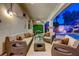 Stylish covered patio featuring comfortable seating, ceiling fan, and views of the pool and beautifully landscaped backyard at 733 Secret London Ave, Las Vegas, NV 89178