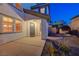 Home's entry with a cozy covered porch, a modern gray door, and low-maintenance landscaping at 733 Secret London Ave, Las Vegas, NV 89178