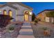 Inviting home entrance with stone steps, desert landscaping, and a charming front door at 733 Secret London Ave, Las Vegas, NV 89178