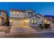 Inviting two-story home with a well-manicured lawn, a two-car garage, and exterior lighting at 733 Secret London Ave, Las Vegas, NV 89178