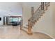 Foyer with staircase and view into the living room, featuring neutral tile flooring at 733 Secret London Ave, Las Vegas, NV 89178