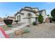 Charming two-story home with landscaped front yard and walkway leading to arched entryway at 733 Secret London Ave, Las Vegas, NV 89178