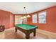 Spacious game room with a pool table, windows, and neutral tile flooring at 733 Secret London Ave, Las Vegas, NV 89178