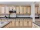 Neutral kitchen features stainless steel appliances and stone countertops at 733 Secret London Ave, Las Vegas, NV 89178