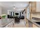 Open-concept kitchen featuring granite countertops, stainless steel appliances, and a seamless flow into the dining and living areas at 733 Secret London Ave, Las Vegas, NV 89178
