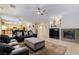 Open-concept living area with fireplace, tile floors, and view of the kitchen and staircase at 733 Secret London Ave, Las Vegas, NV 89178