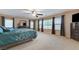 Spacious main bedroom with many windows, neutral walls, carpeted floor, a ceiling fan, and ample closet space at 733 Secret London Ave, Las Vegas, NV 89178