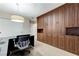 Office featuring a built-in, wooden storage system, neutral walls, carpeted flooring, and a statement light fixture at 733 Secret London Ave, Las Vegas, NV 89178