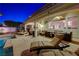 Covered patio with lounge chairs, dining furniture, and a view of the pool, perfect for relaxation and entertainment at 733 Secret London Ave, Las Vegas, NV 89178